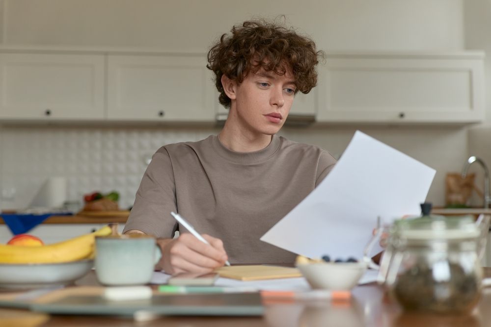 Close,up,of,young,curly,haired,handsome,man,wearing,beige