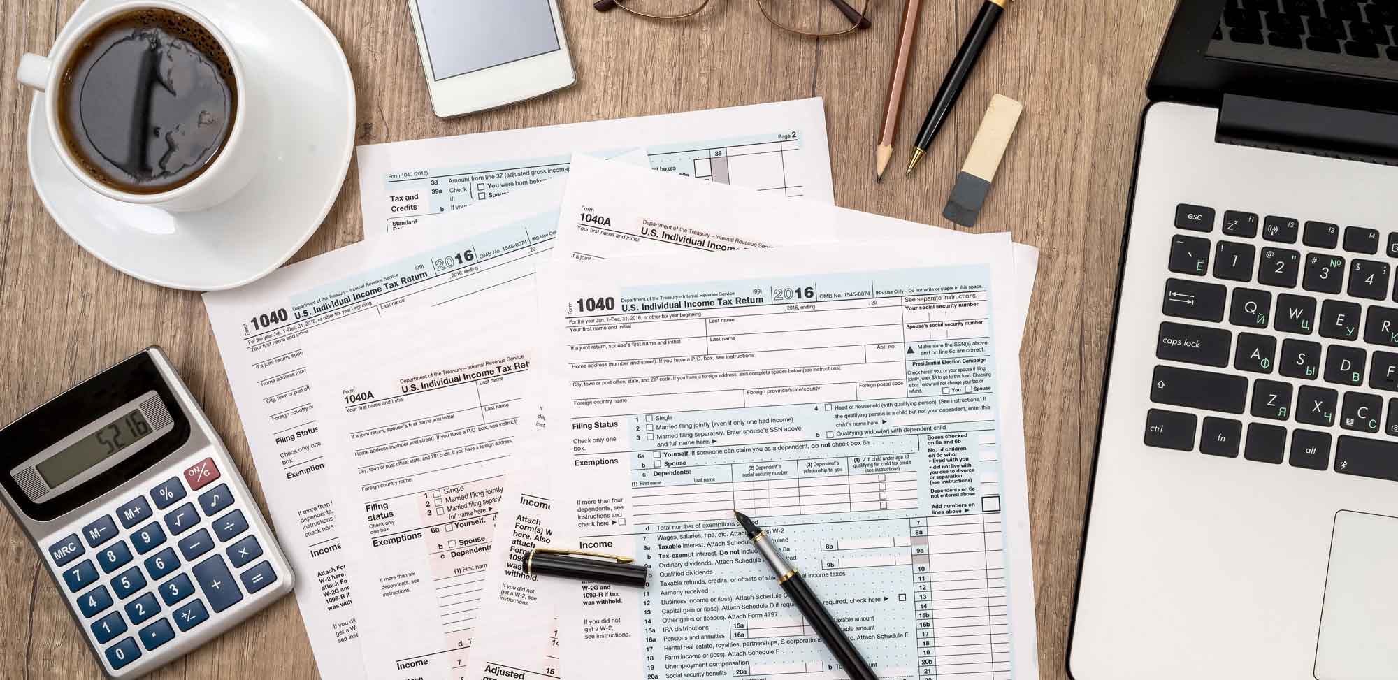 1040,tax,form,,laptop,,glasses,,coffee,on,desk